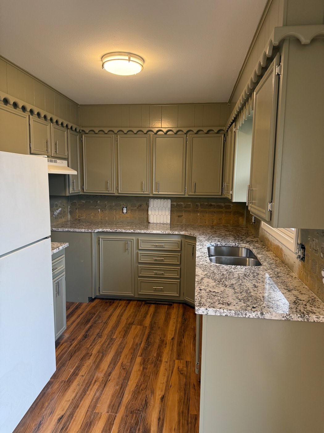 Kitchen with freshly painted sage green cabinets