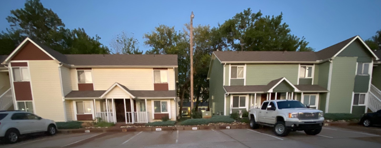 Townhome exterior repaint in progress, new sage green color next to the original color scheme