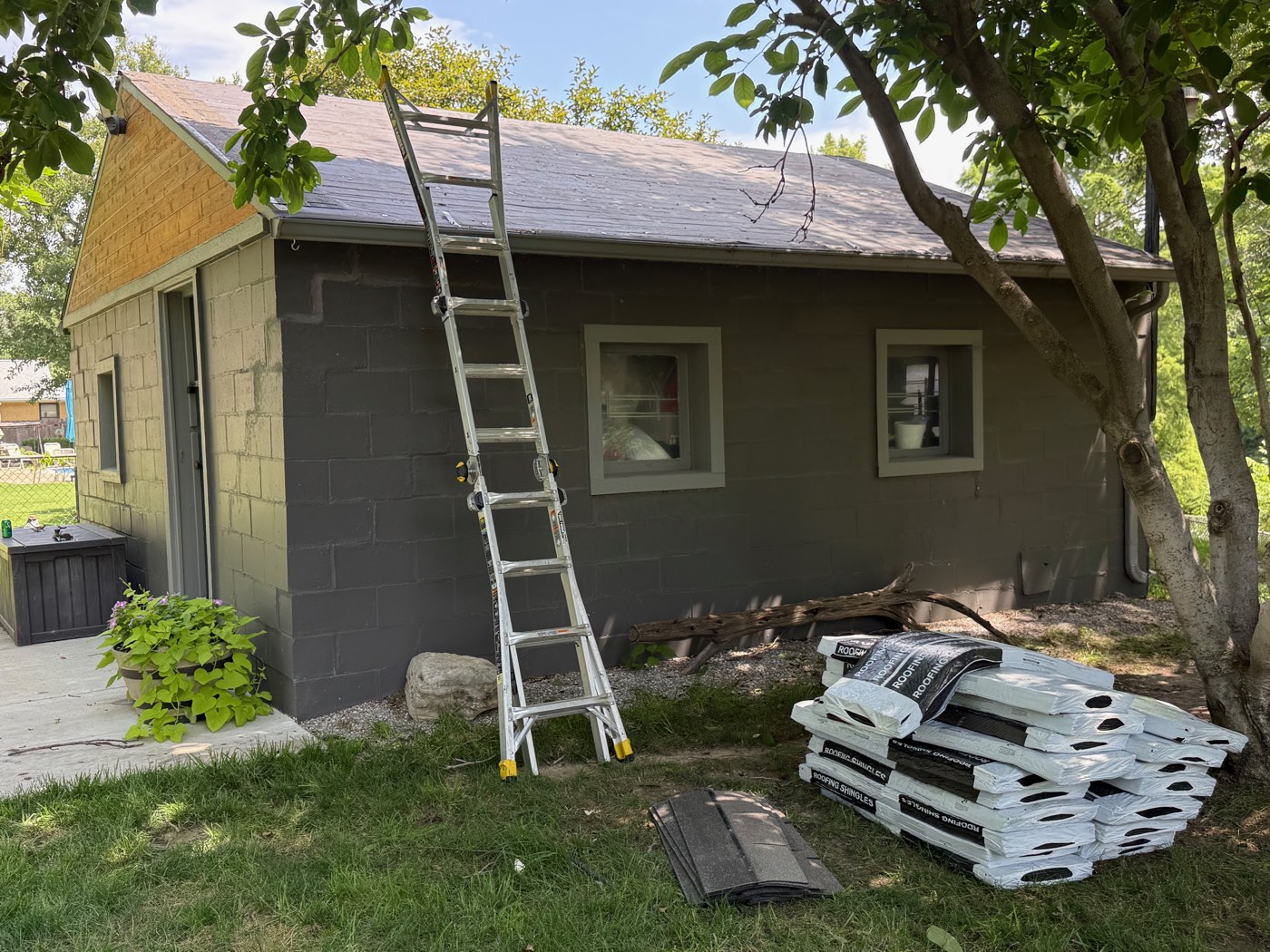 Roofing shingles staged for a detached garage roof replacement