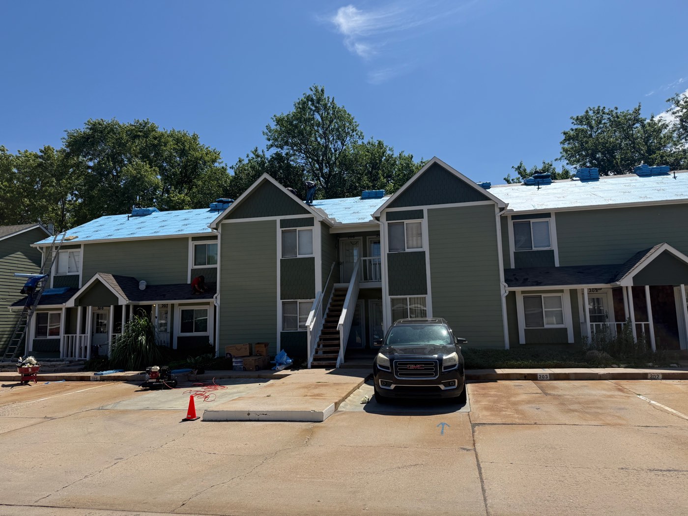 Roof replacement in progress on a Wichita townhome building